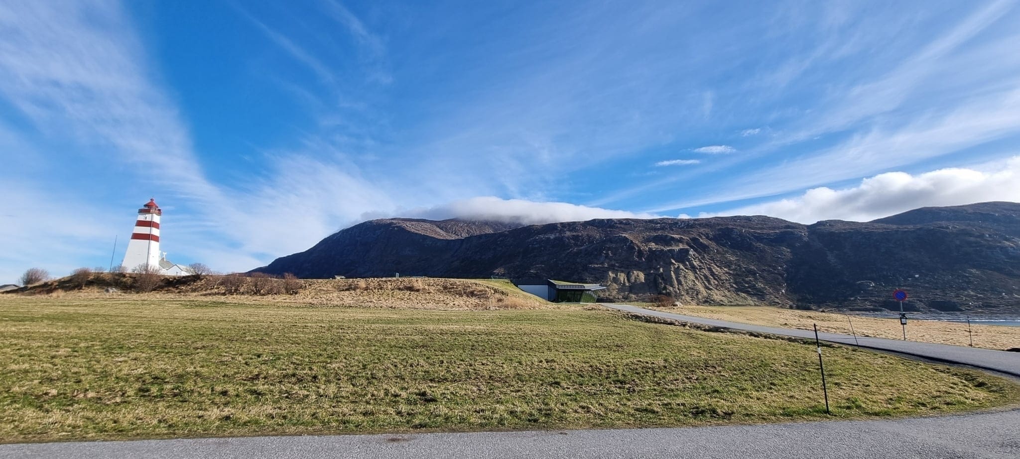 Alnes Lighthouse with distant mountains on Godøya