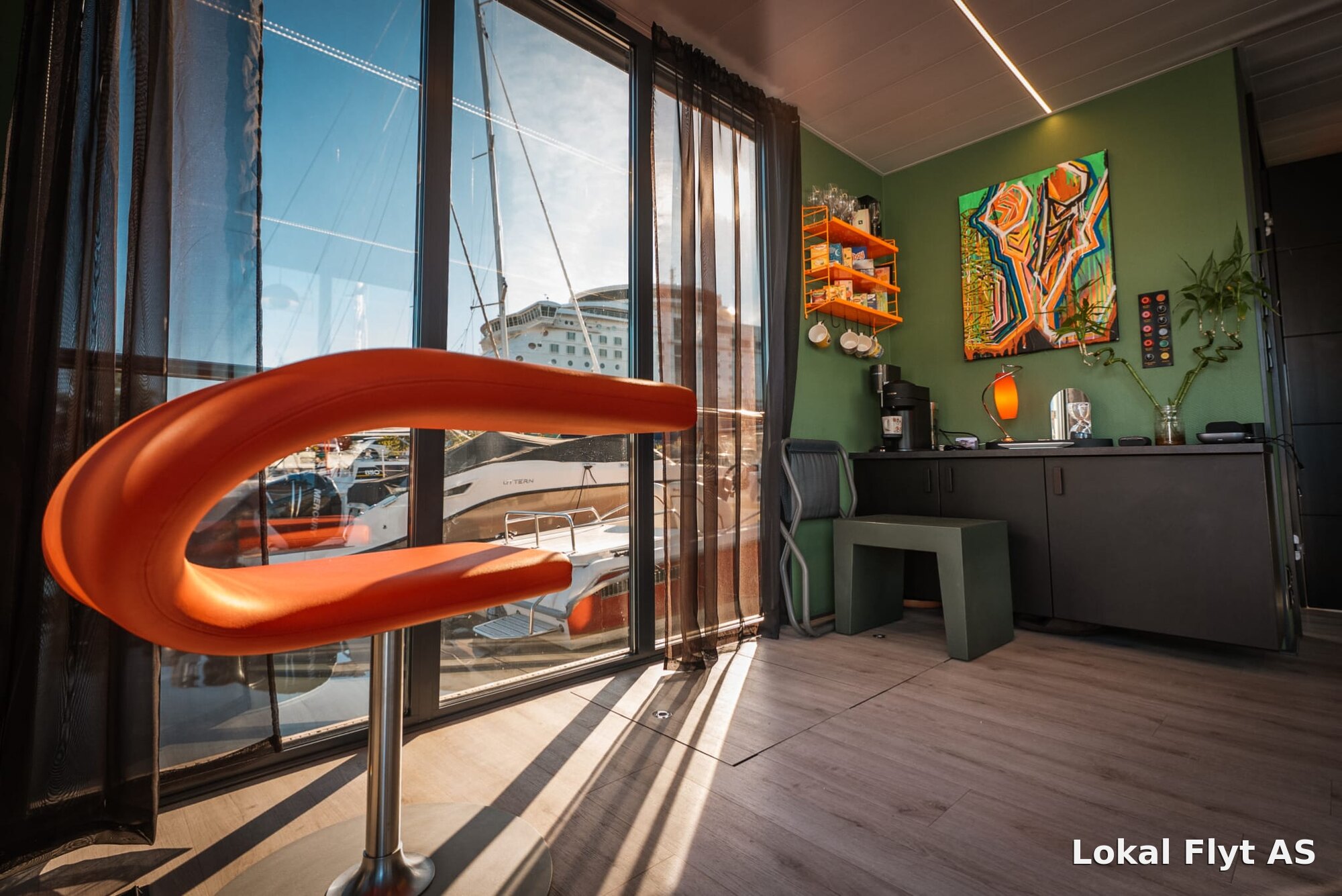 Glass-walled lounge aboard the houseboat Pur