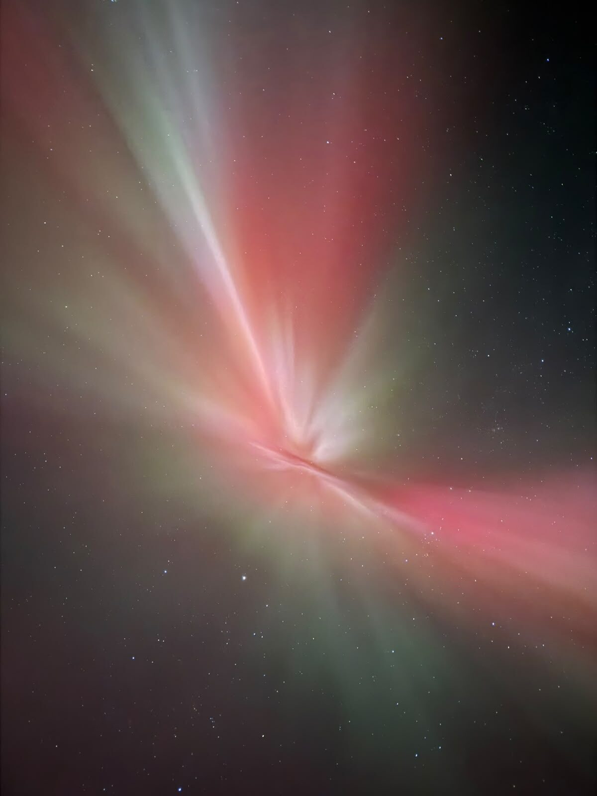 Pink and green aurora corona directly overhead